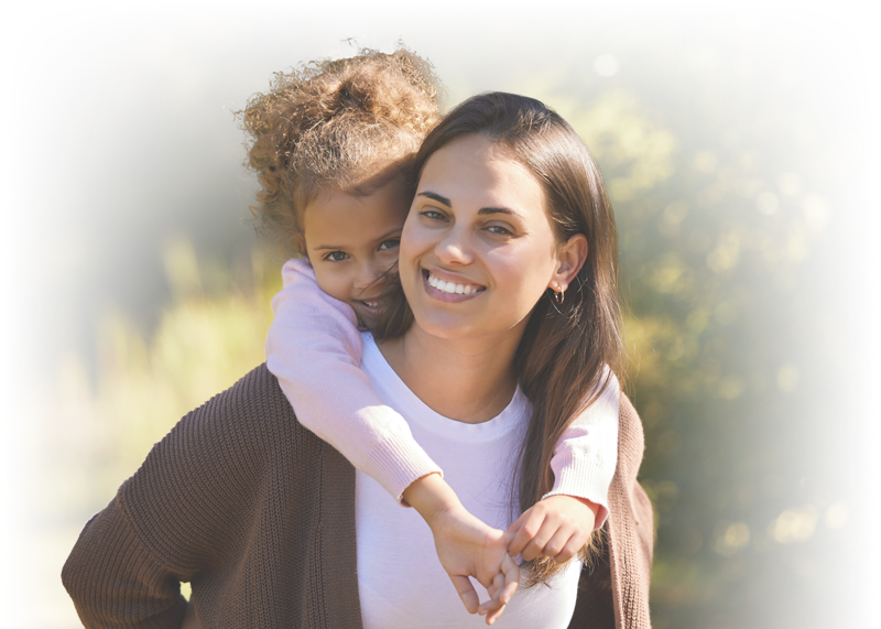 daughter getting piggyback ride from mother