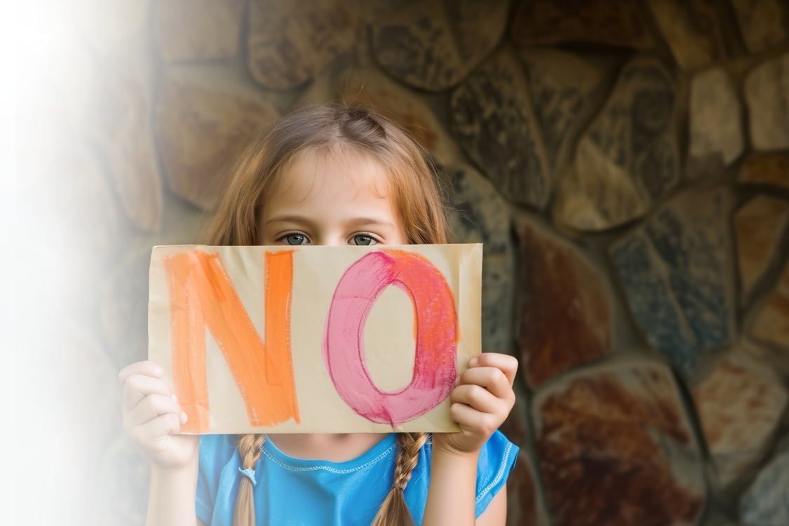 Little Girl with dark blonde hair with a sign that says no