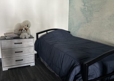 Children's bedroom with stuffed animals on the dresser