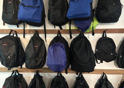 Rows of backpacks hung on the wall