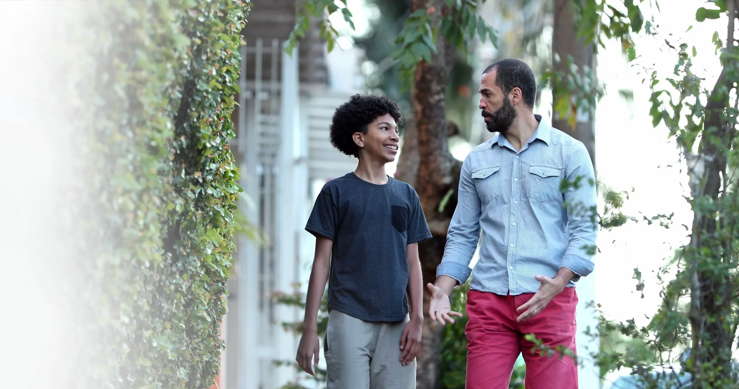 Son speaking with father on a walk